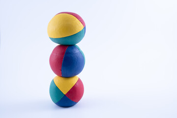 vertical stacke of three leather hand made and stitched professional  juggling balls isolated on a white background