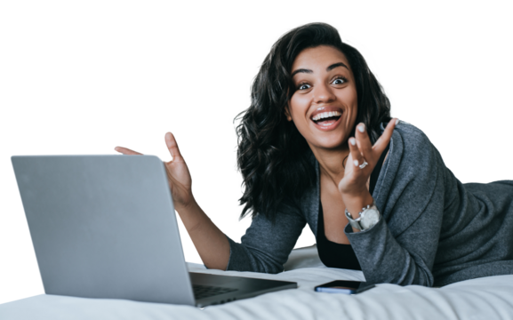 Excited African American young woman in grey cardigan toothy smiles laying on couch with laptop surprised opened mouth in disbelief amazed by new gadget. Student against transparent background. Winner