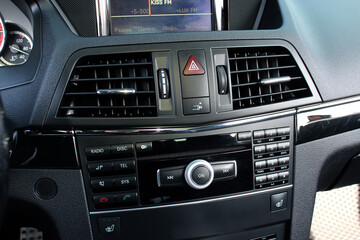 Fototapeta premium Multimedia radio cd controls. Modern car climate control panel for driver and passenger with shallow depth of field. Zone climate control. Car interior detail.