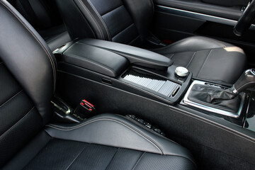 Fototapeta na wymiar Luxury leather interior sport car. Sport car interior. Sport car armrest. Luxury car armrest.