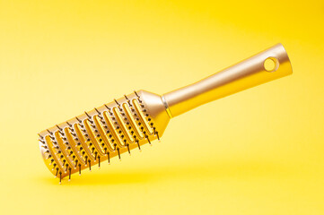 Fototapeta na wymiar Massage comb close up on a yellow background