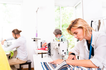 Obraz premium Team of fashion designers at work in a clothing brand start-up