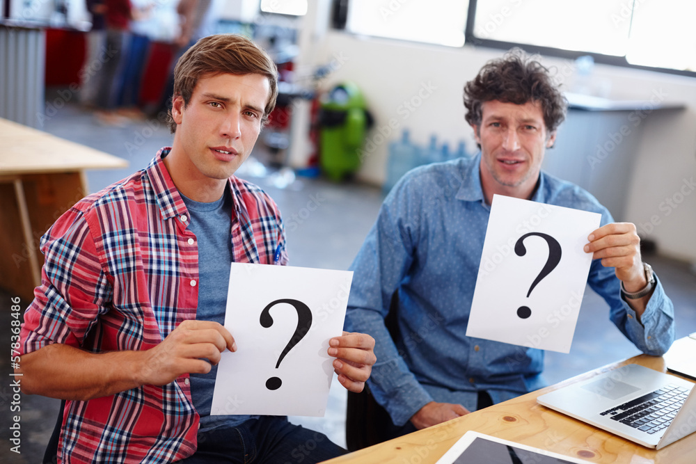Poster theyre a little confused...portrait of two coworkers looking confused while holding question mark si