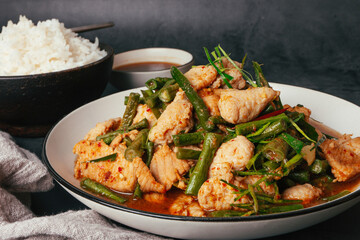 Close up Tasty Stir-fried pork and red hot curry paste with or long bean and Ingredients are oyster sauce, fish sauce, sugar, kaffir lime leaves in the dish Eat with cooked rice. Thai food