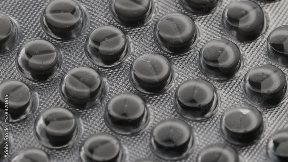 Poster white pills in the shape of a heart in a blister are rotated in a circle