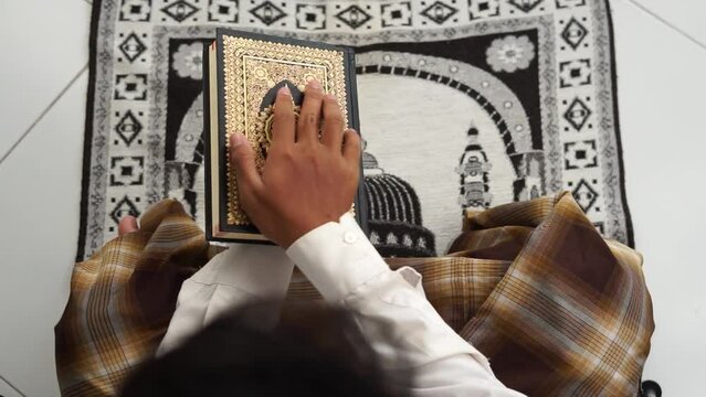 Man open the holy Quran