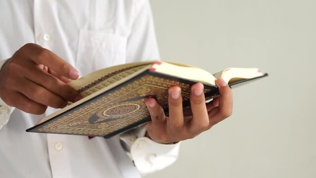 Man open and read holy Quran book