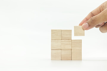 businessman hand picking up wooden blank block cubes ,arranged in squares shape on white background.