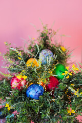 Beautiful bouquet of spring blooming bush with easter eggs on pink background. 