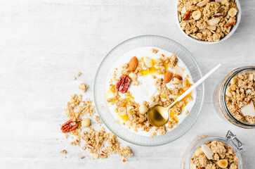 Granola with Nut Mix and Yogurt in a Boal, Healthy Breakfast, Muesli with Nuts and Honey on Bright...