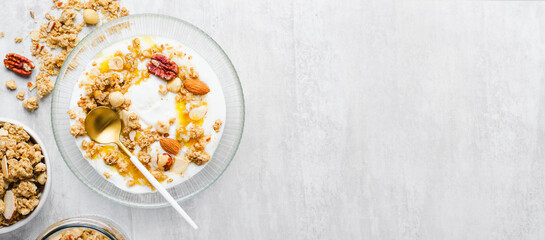 Granola with Nut Mix and Yogurt in a Boal, Healthy Breakfast, Muesli with Nuts and Honey on Bright Background