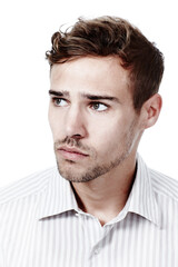 Fototapeta premium Mulling things over. Cropped studio shot of a pensive young man isolated on white.