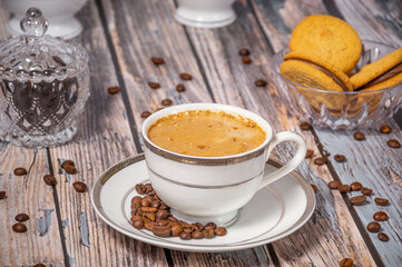 Coffee cup,coffee beans and sweets on the background