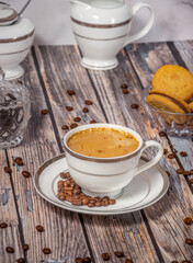 Coffee cup,coffee beans and sweets on the background