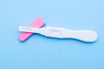 Positive pregnancy test on a blue background. Healthcare concept 