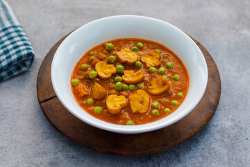 Spicy button mushroom curry cooked with green peas.   - obrazy, fototapety, plakaty