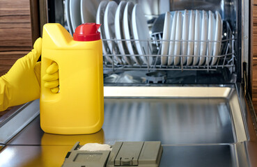 open dishwasher with dishes and dishwashing powder, using eco products for cleaning and cleanliness...
