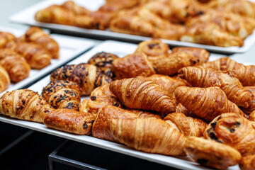 Delicious crunchy croissants at a breakfast buffet at a hotel.