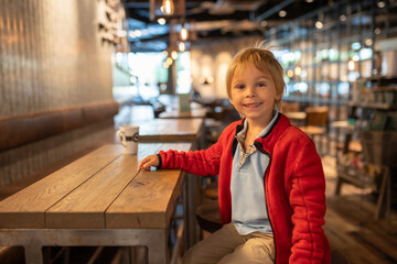 Child, visiting little town in south Norway, Arendal, on a rainy summer day