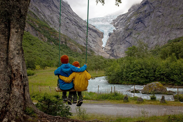 Child, cute boy, toddler enjoying the amazing view of the glacier in.Jostedalsbreen national park