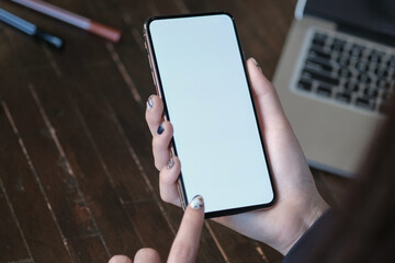 Women's hands holding cell telephone blank copy space screen. smart phone with technology concept.