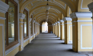Obraz premium Yellow arched Colonnade of the Old Gostiny Dvor, Dumskaya Street, St. Petersburg, Russia, february2023