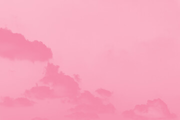 Pink clouds on light pink sky background,