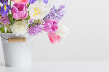 spring flowers in bucket on white  background