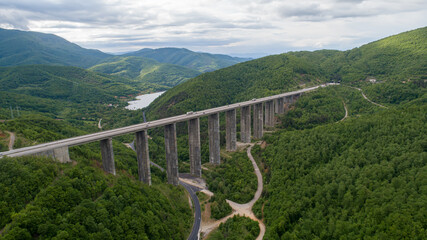 Fototapeta na wymiar Aerial view of highway and beautiful natural landscape. Mountain bridge.