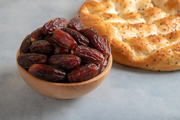 Date fruits,traditional ramadan pita on bright background