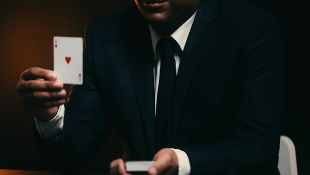 Man in business suit showing card and smiling, lucky chance to win, betting