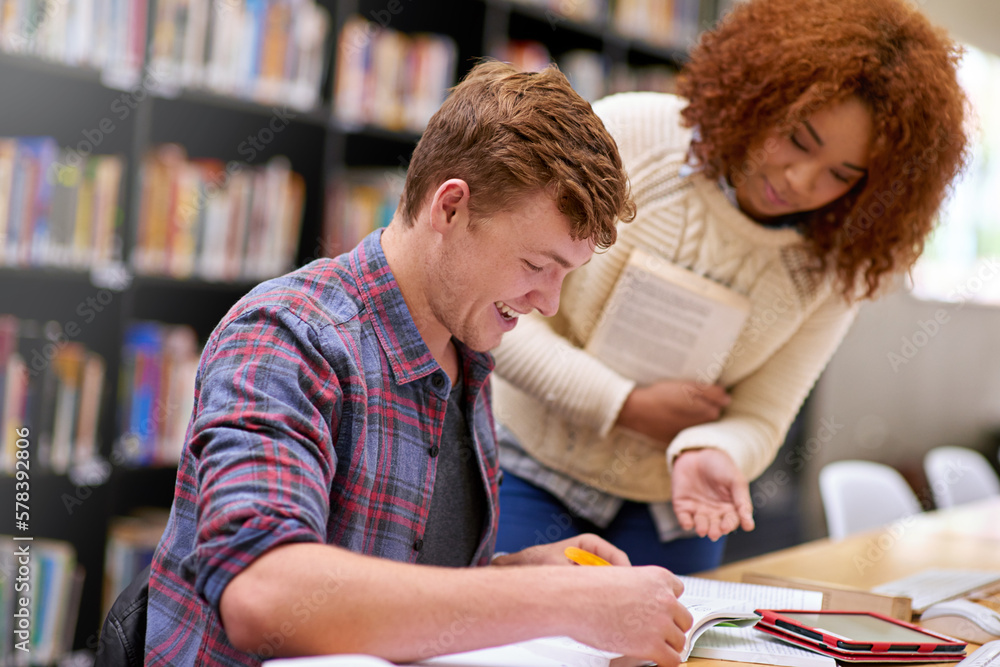 Poster working towards his academic goals. students studying in a college library.