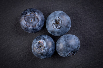 Blueberries on stone plate background