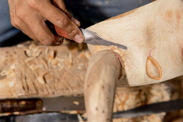 latino man carving with his hands bull figure closeup