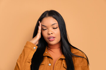 annoyed african american woman with sad face expression in beige colors. frustration, unhappy,...