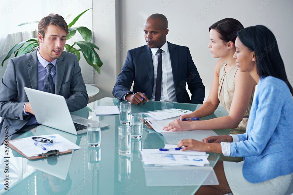 Poster coming up with business solutions as a team. a businessman showing his colleagues something on a lap