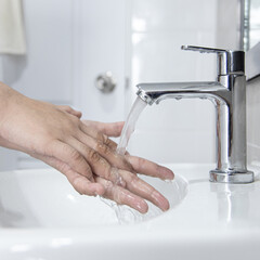 Men are washing their hands in the sinks to clear respiratory bacteria and viruses, sanitation and reduce the spread of COVID-19 that is spread around the world, Hygiene ,Sanitation concept.