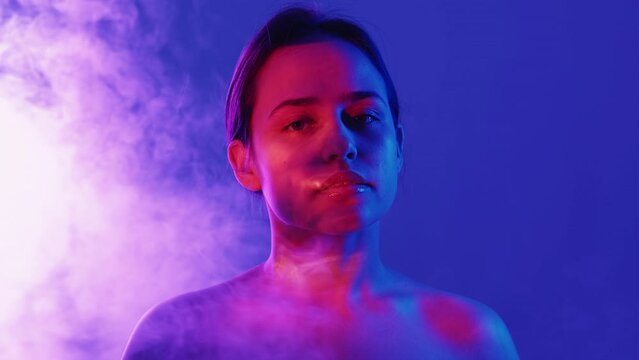 Female beauty. Neon light portrait. Peaceful harmony. Tranquil woman posing blue background red purple shadow light reflection overlay smoke blowing double exposure.