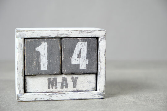 May 14 calendar made wooden cubes gray background.With an empty space for your text.