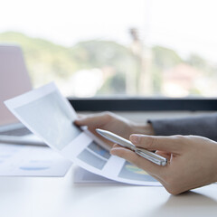 Financial businesswomen analyze the graph of the company's performance to create profits and growth, Market research reports and income statistics, Financial and Accounting concept.