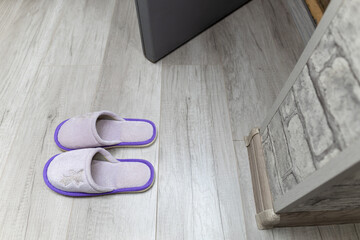 home slippers stand near the threshold of the house.