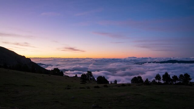 Coll de Pal, Bergued&agrave;, Girona, Spain. August 2022. Watch the breathtaking sunrise over the mountains as a sea of clouds ebbs and flows, creating a stunning splash-like effect against the peaks.