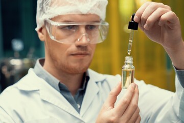 A scientist or apothecary extracts CBD hemp oil for medicinal purposes in a laboratory. Alternative...