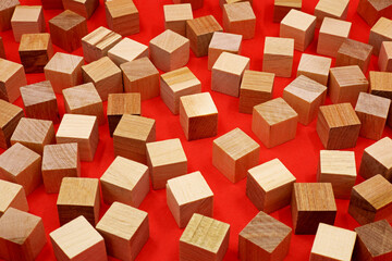 small wooden cube blocks on a red background
