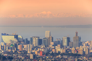 the city of batumi against the backdrop of the caucasian mountains at sunset