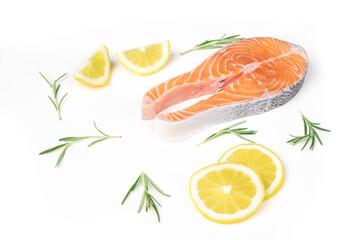 Fresh raw salmon slices with lemon and rosemary arranged on a white background. Healthy seafood food. Top view.