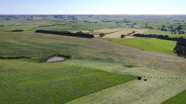 Harvest time on the farm. Time lapse of Harvesting silage and hay in a field. Baling and wrapping hay for live stock feed