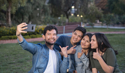 group of friends taking funny selfies outdoors