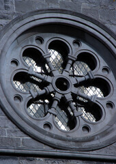 circular church window in grey stone