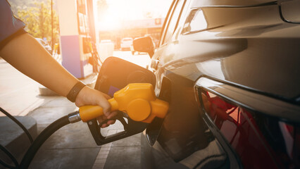 Gasoline being refilled at a petrol station. Refueling Diesel fuel is used to power a car.